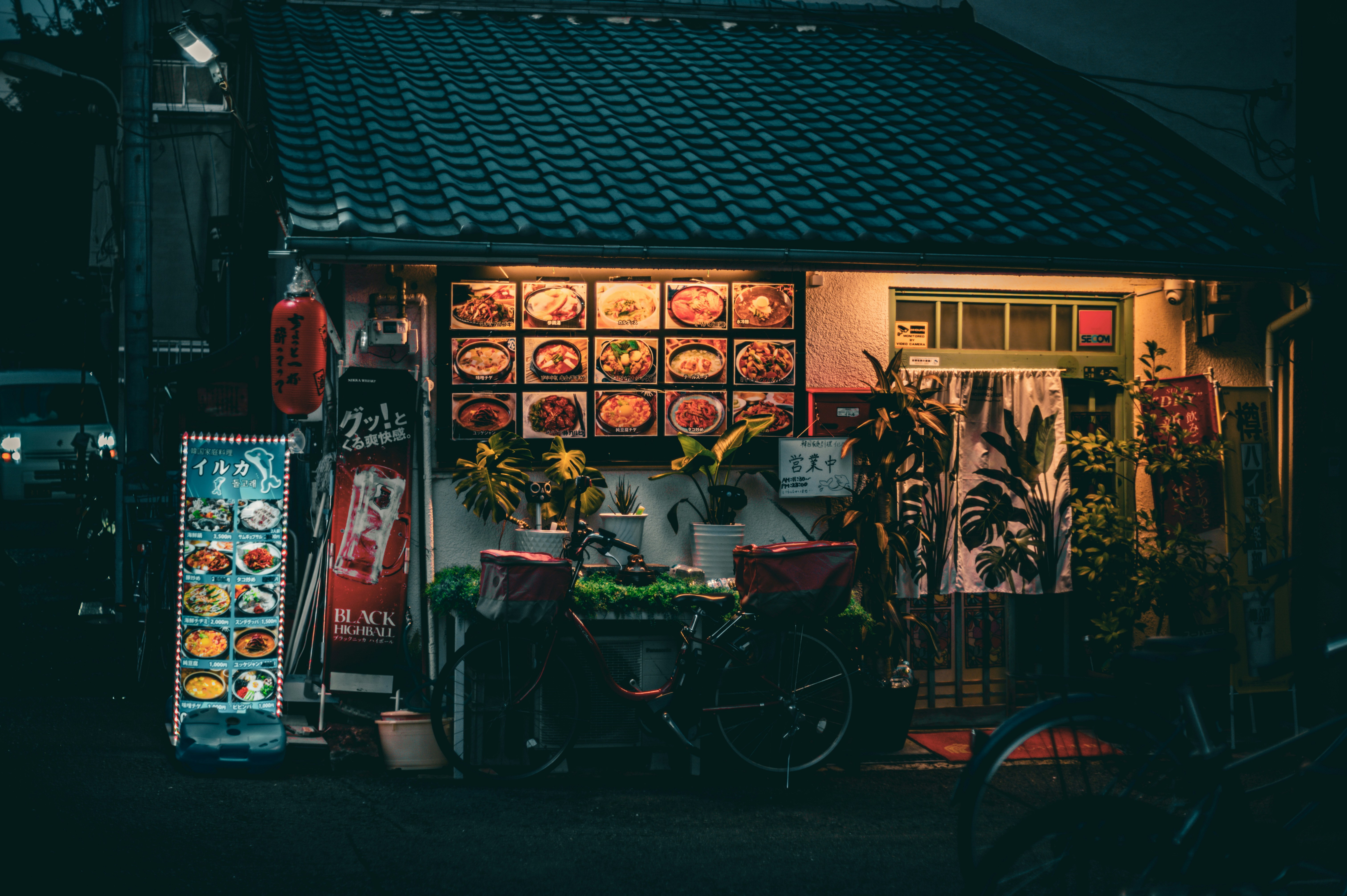 Small restaurant with glowing menu displays at night