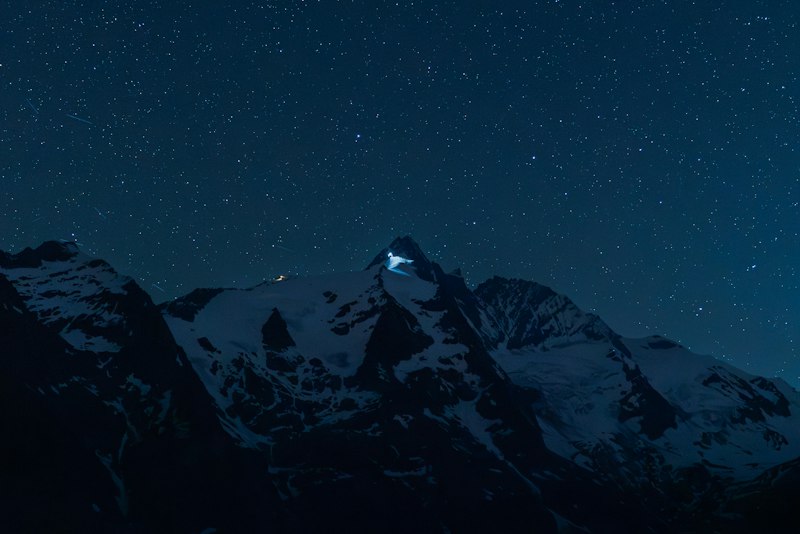 Snowy mountains under a starry night sky