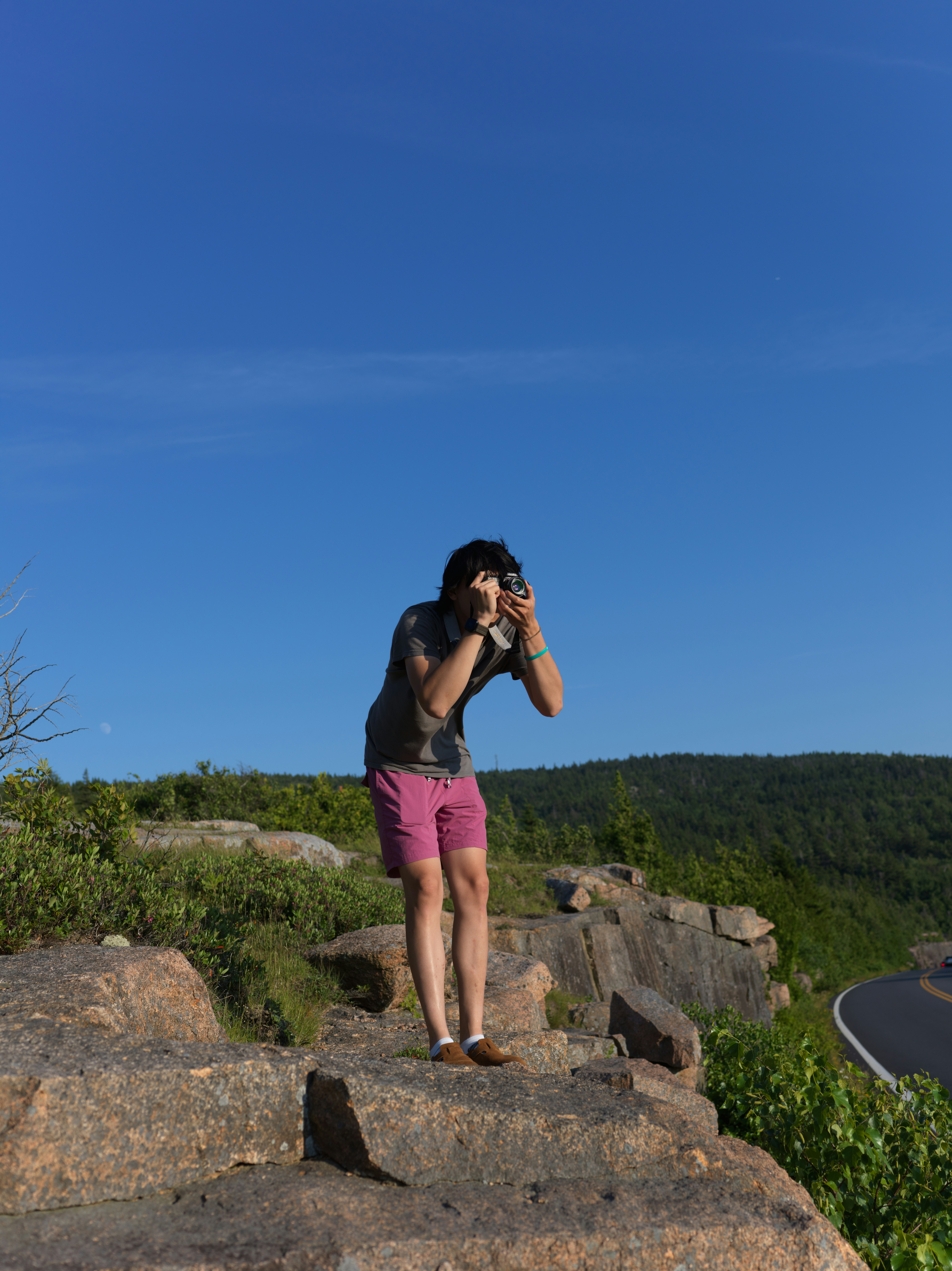 Person taking a picture on a rocky outcrop
