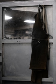 Leather apron hanging on a metal door