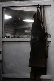 Leather apron hanging on a metal door