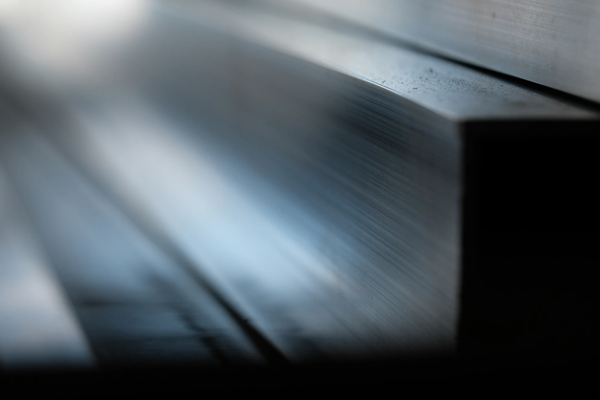 Reflective coated metal surface suggesting thermal and coating processes