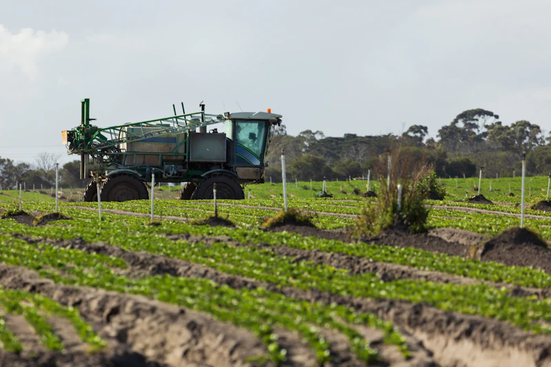 Agricultural sprayer applying crop protection product in a field