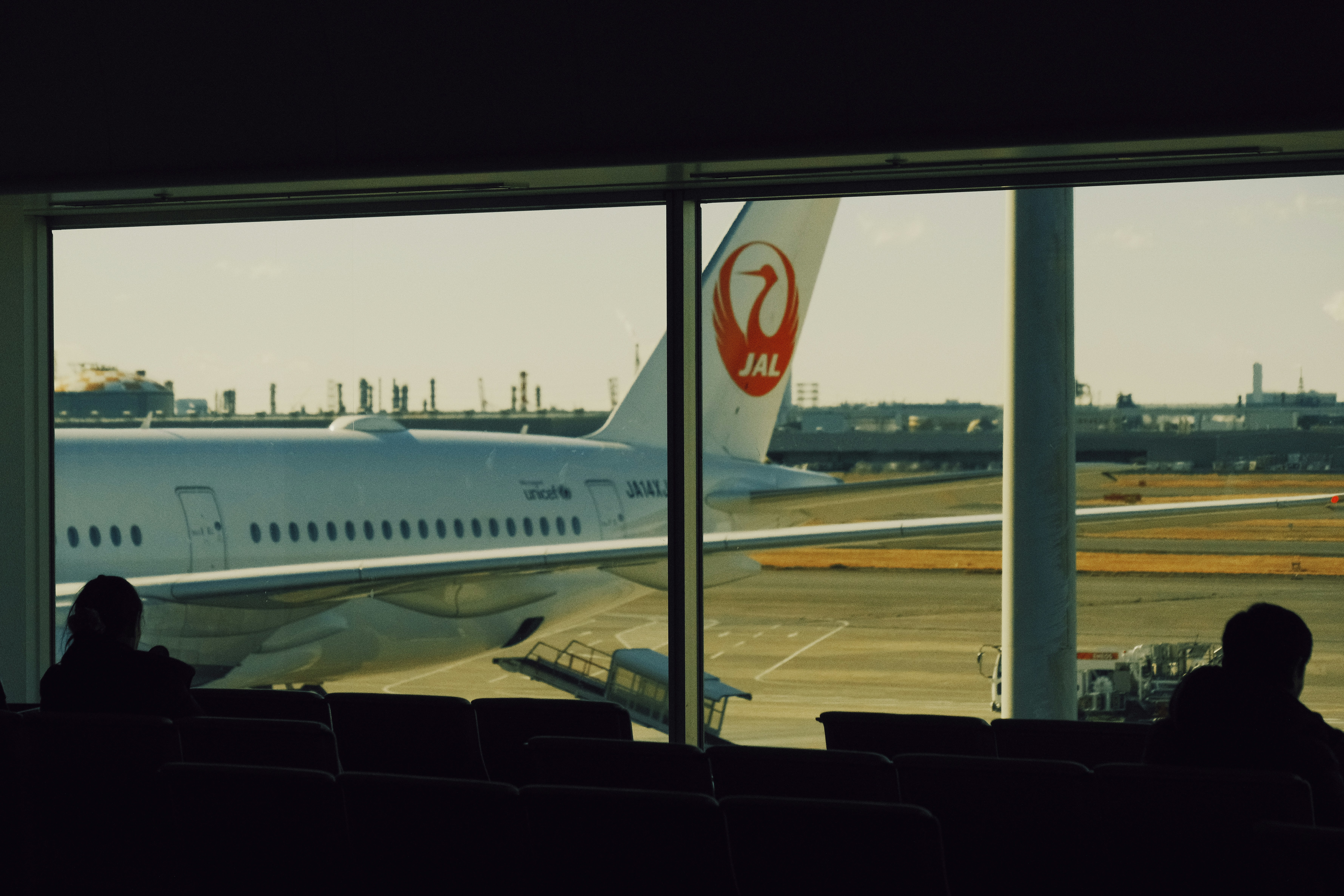 Airplane at airport gate seen through window