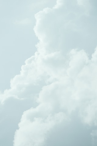 Soft white clouds against a pale blue sky