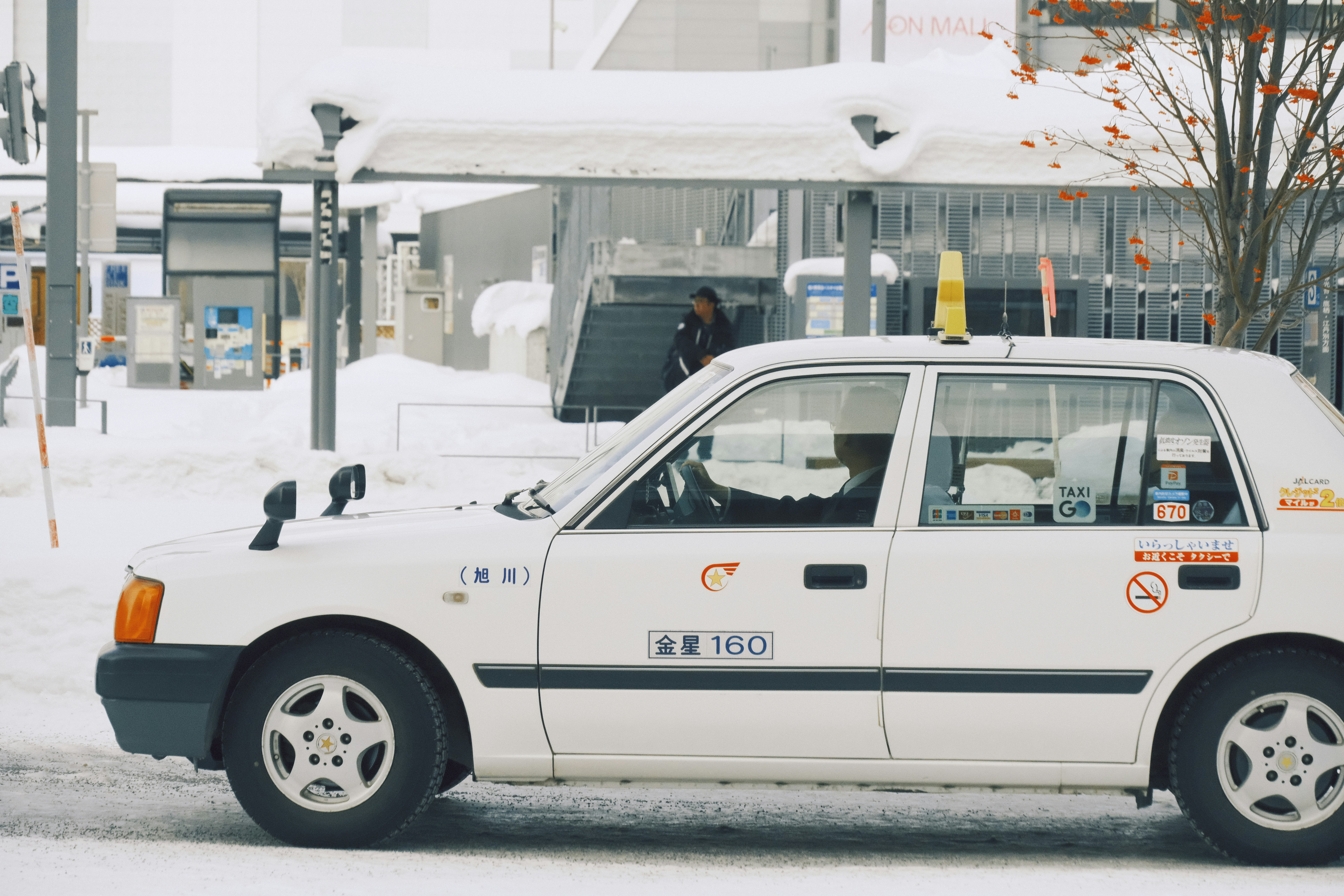 White taxi parked on a snowy street