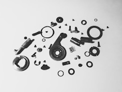 Assortment of mechanical parts scattered on a white background.