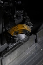 Close-up of industrial machinery with metal shavings.