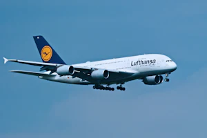 Lufthansa passenger jet flying in a clear blue sky