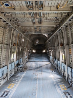 Interior of an empty cargo airplane with metal walls.