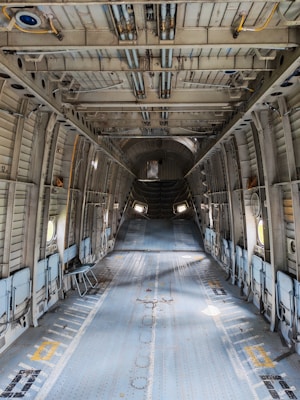 Interior of an empty cargo airplane with metal walls.