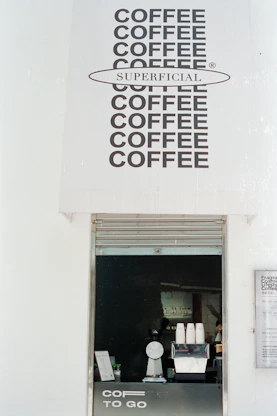 Coffee shop counter with "superficial" branding.