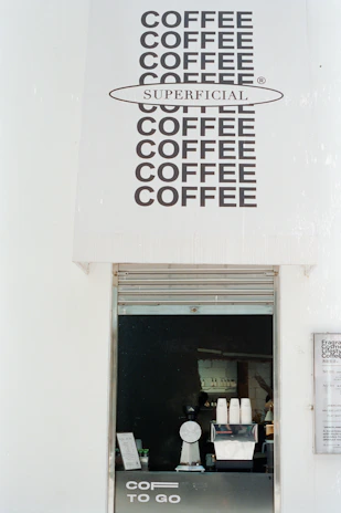 Coffee shop counter with "superficial" branding.