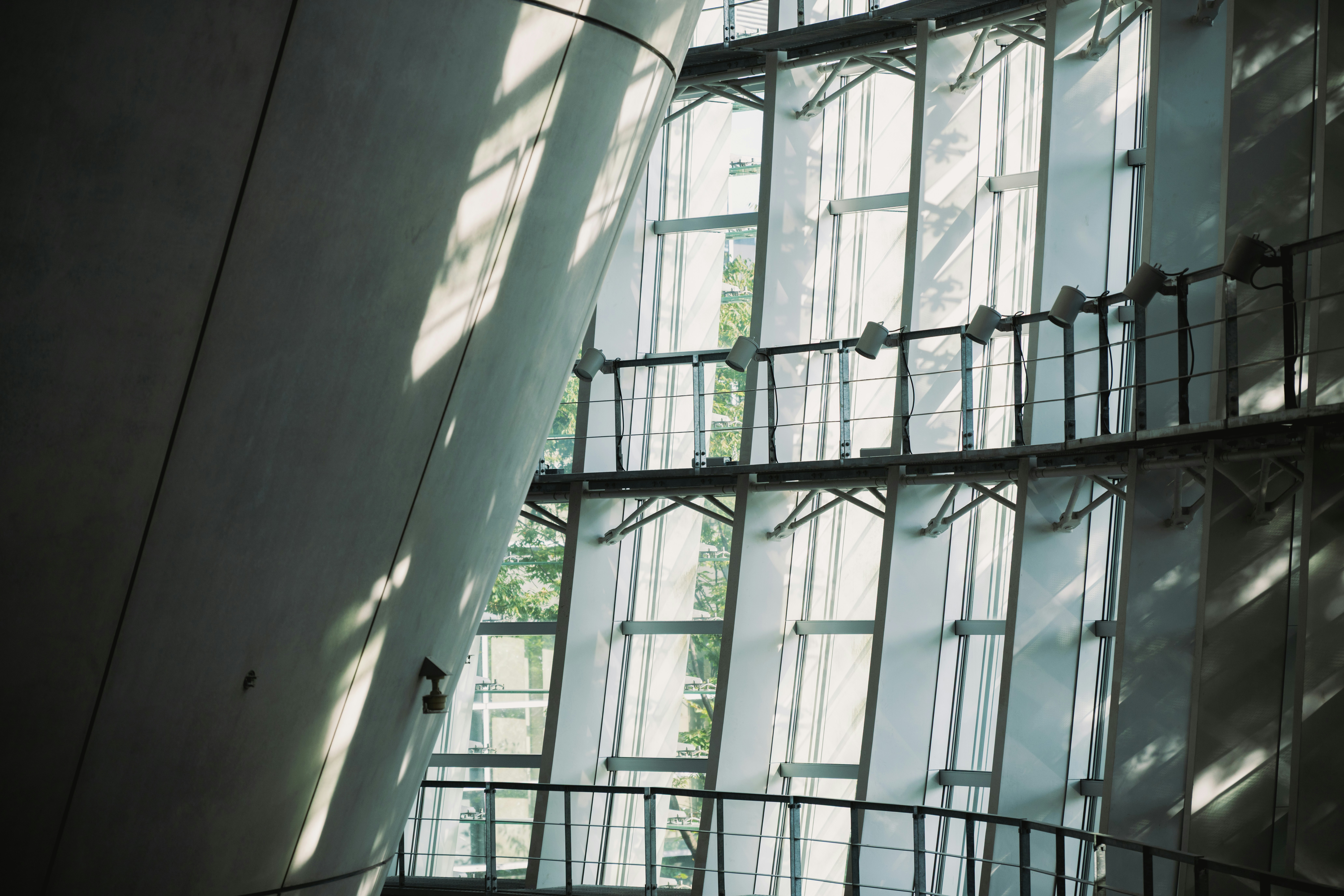 Modern building interior with large windows and shadows.