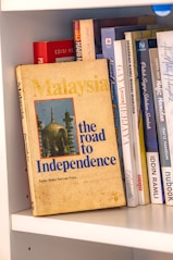 Book titled malaysia: the road to independence on shelf.