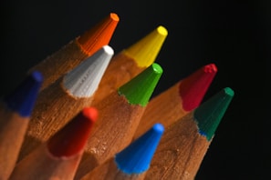 Close-up of sharpened colored pencils on black background