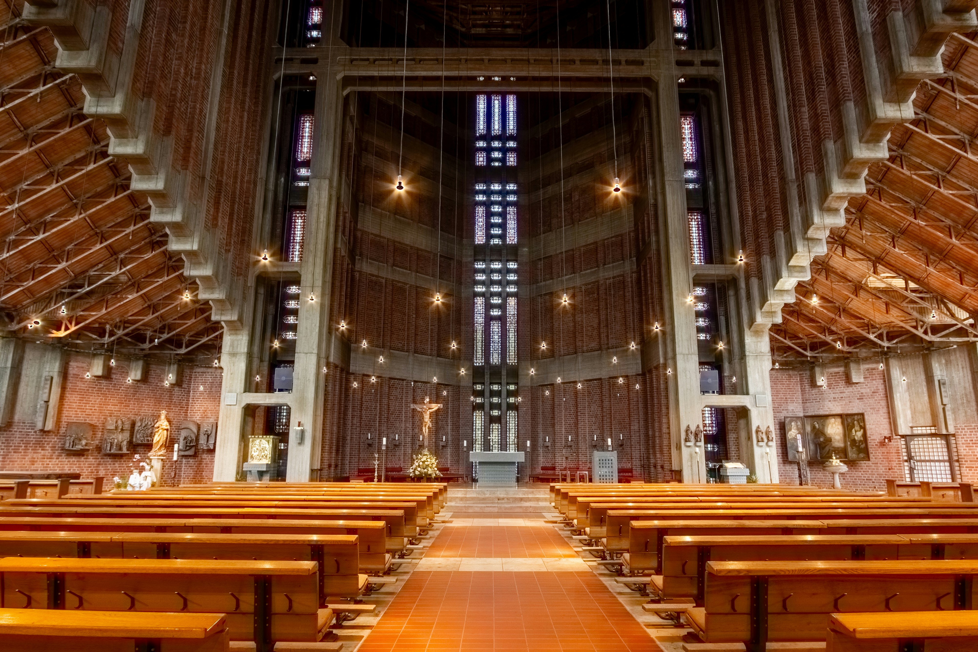 Interior of a modern church with wooden pews and altar.