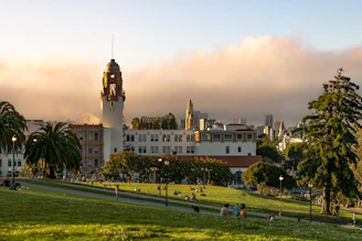 Campus buildings with a tower under a cloudy sky