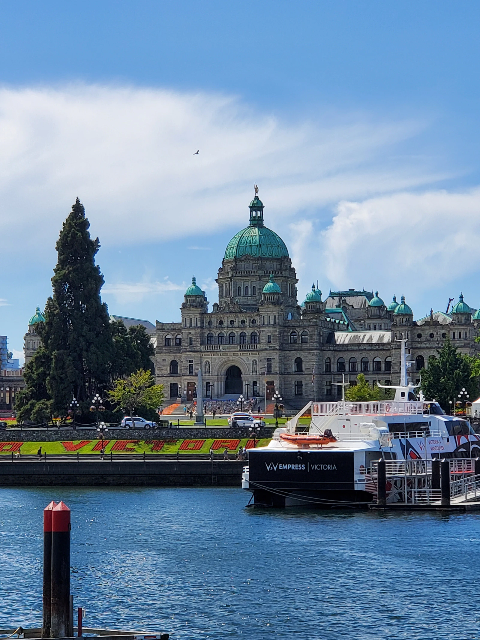 BC Parliament Buildings beside the harbour with a ferry docked