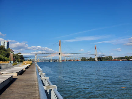 Modern suspension bridge over blue water on a clear day
