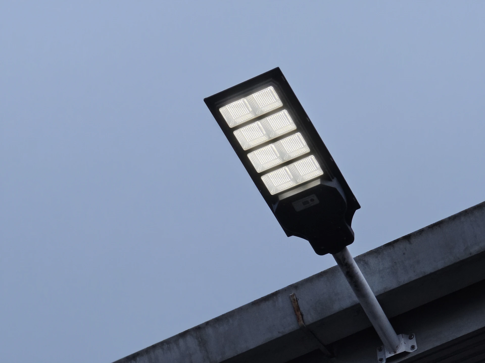Modern led street light against a cloudy sky.