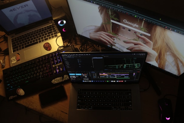 Multiple computer screens displaying work and internet browsing.
