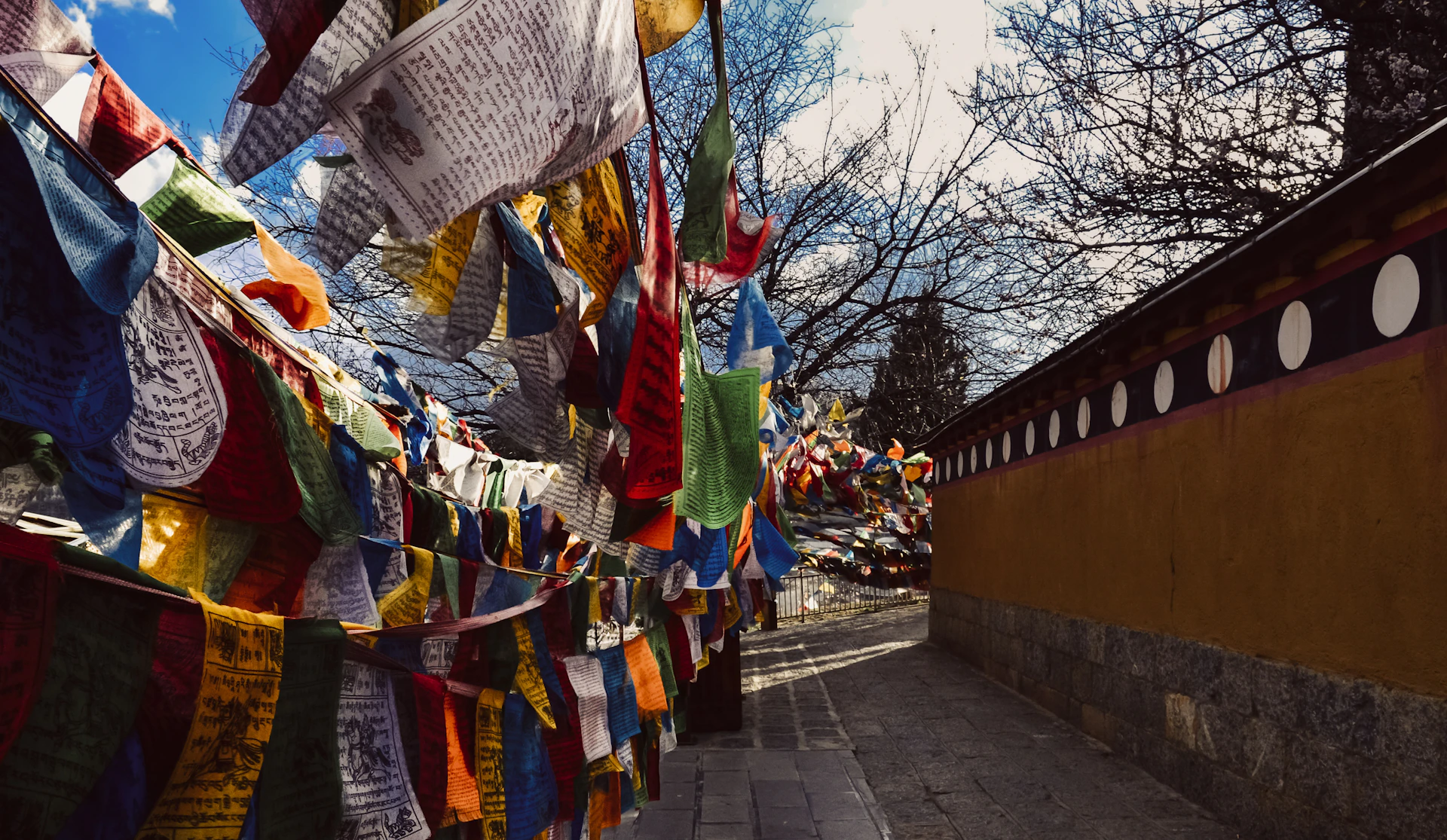 Colorful prayer flags strung along a wall