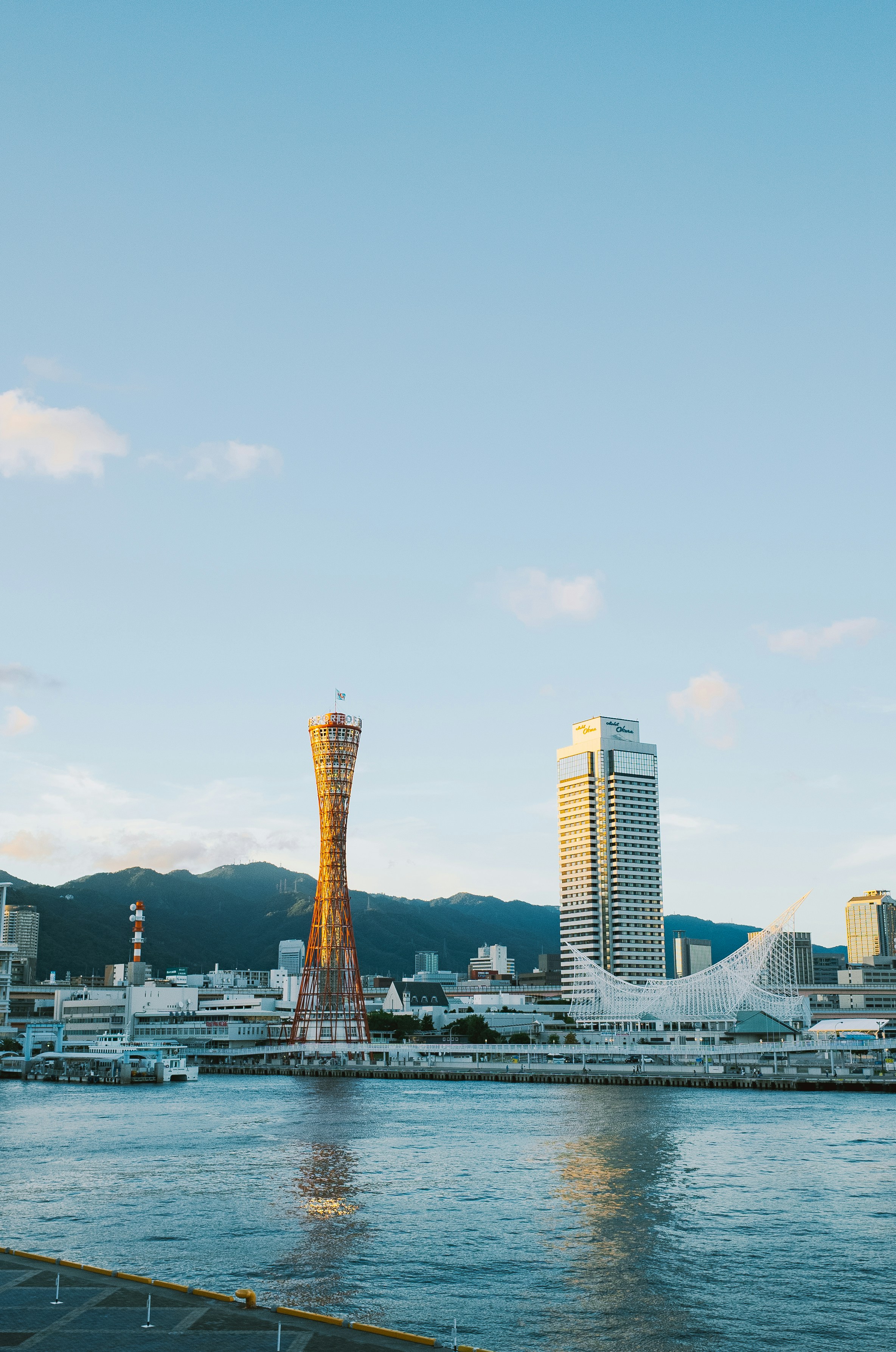 Kobe port tower and modern buildings by the water.