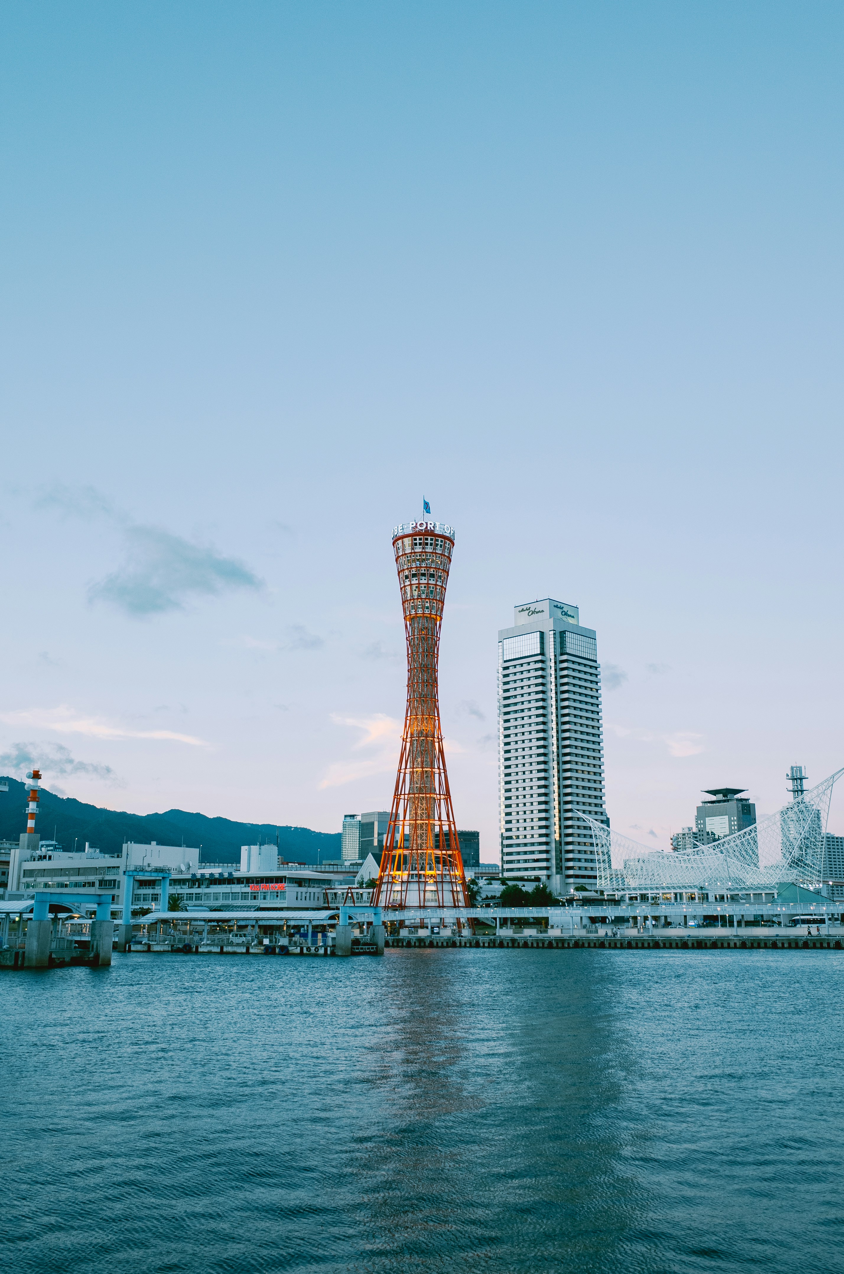 Kobe port tower and modern buildings at dusk.