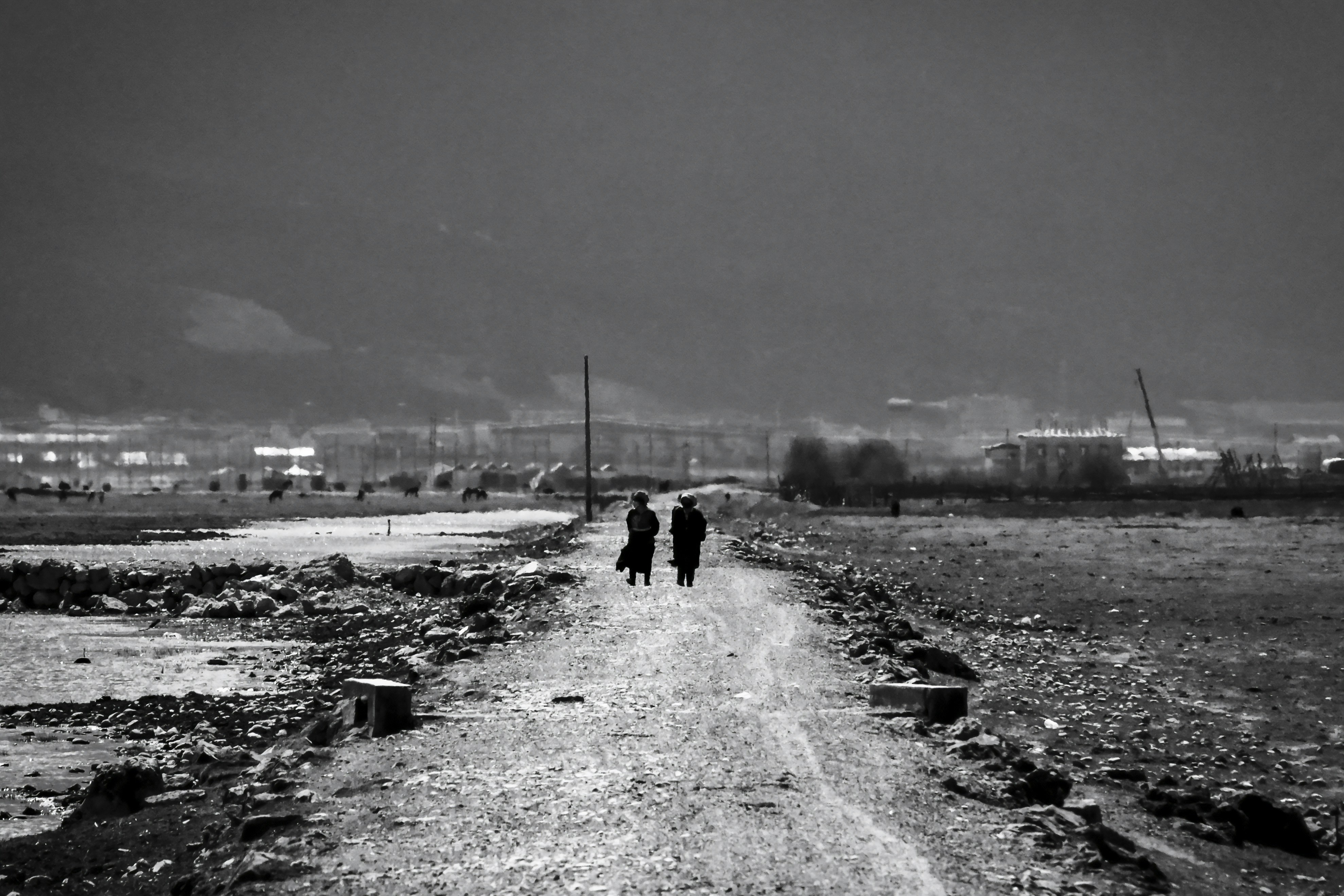 Women on pilgrimage walking dusty road