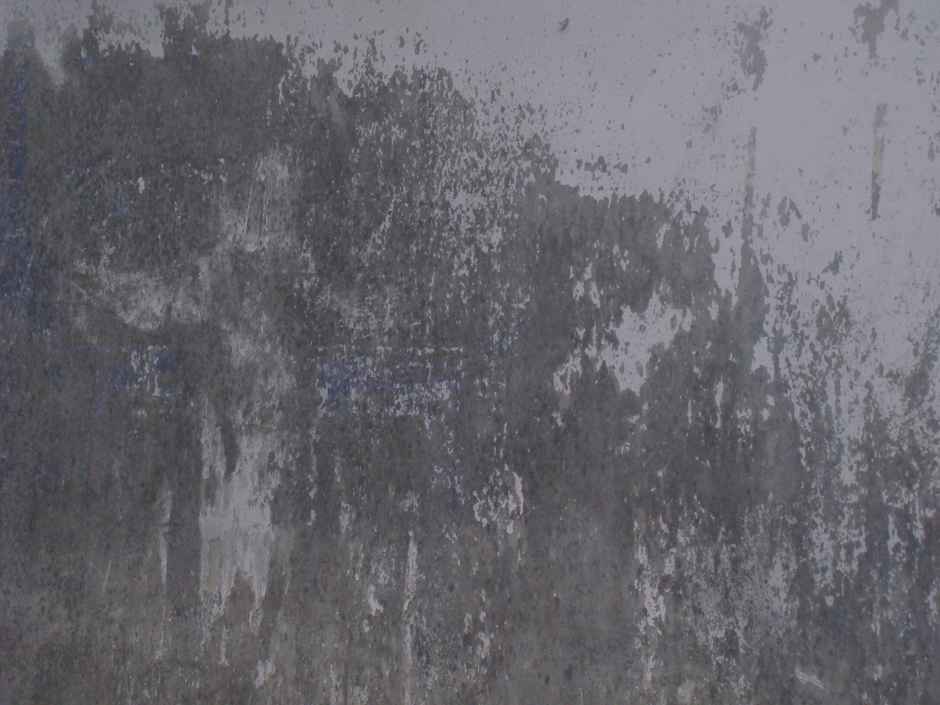 Rough textured concrete wall with peeling paint