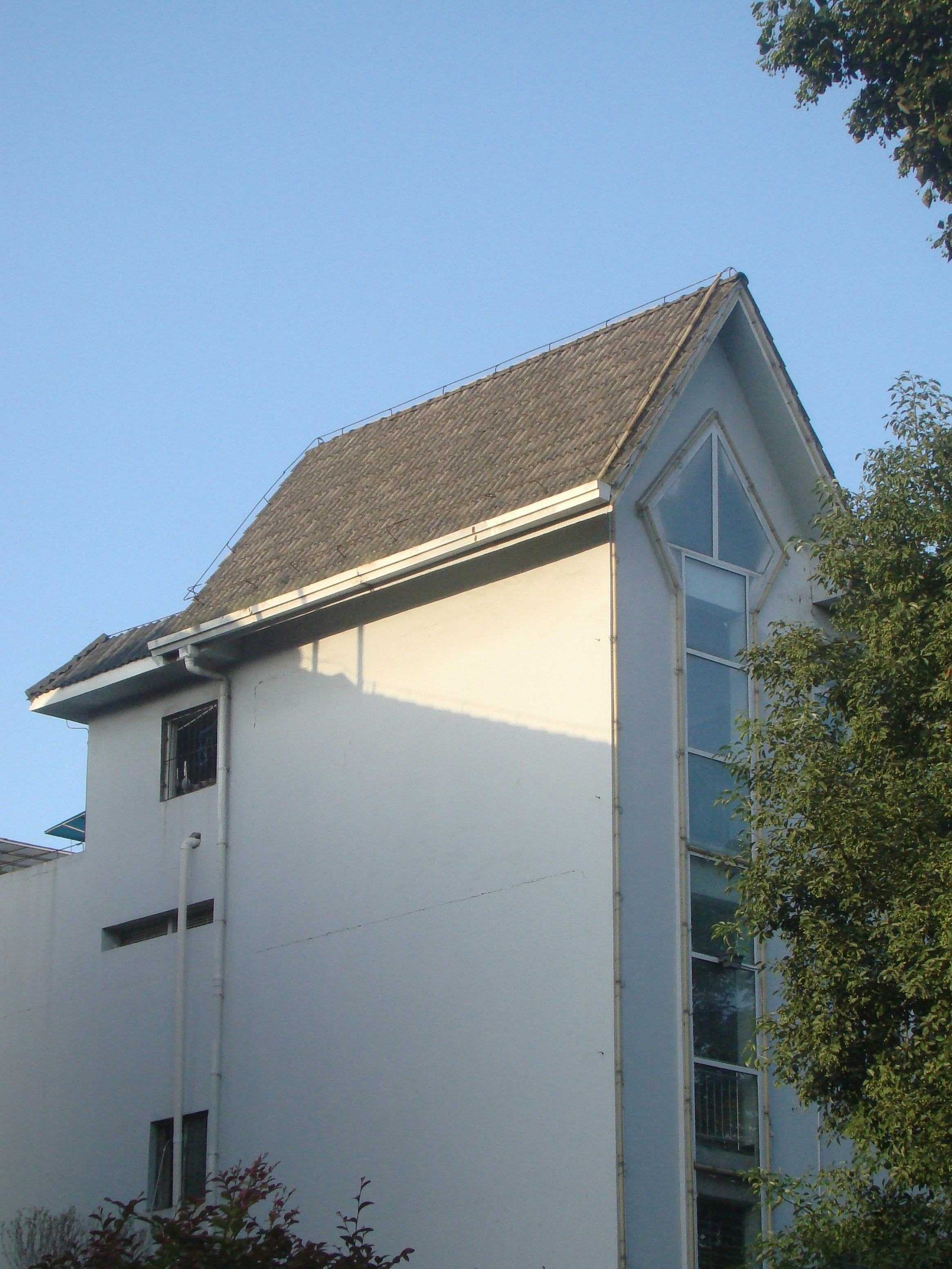 Modern building with a unique angular roof design.