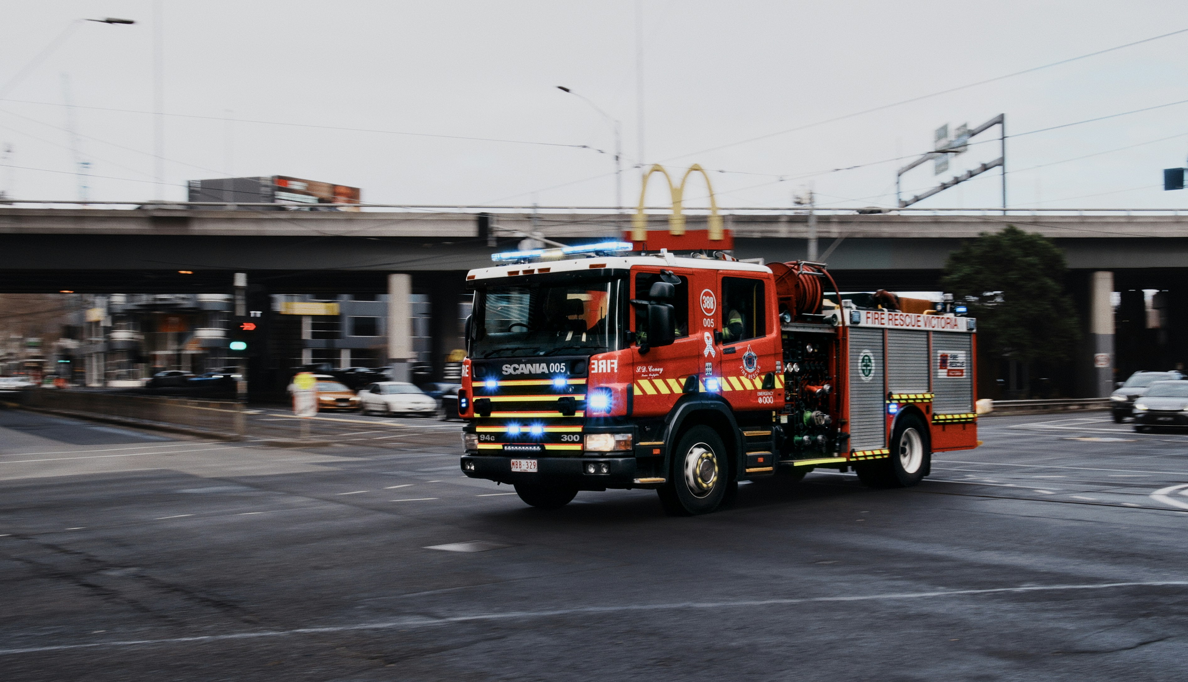 Red fire truck driving on a city street photo – Free Car Image on Unsplash