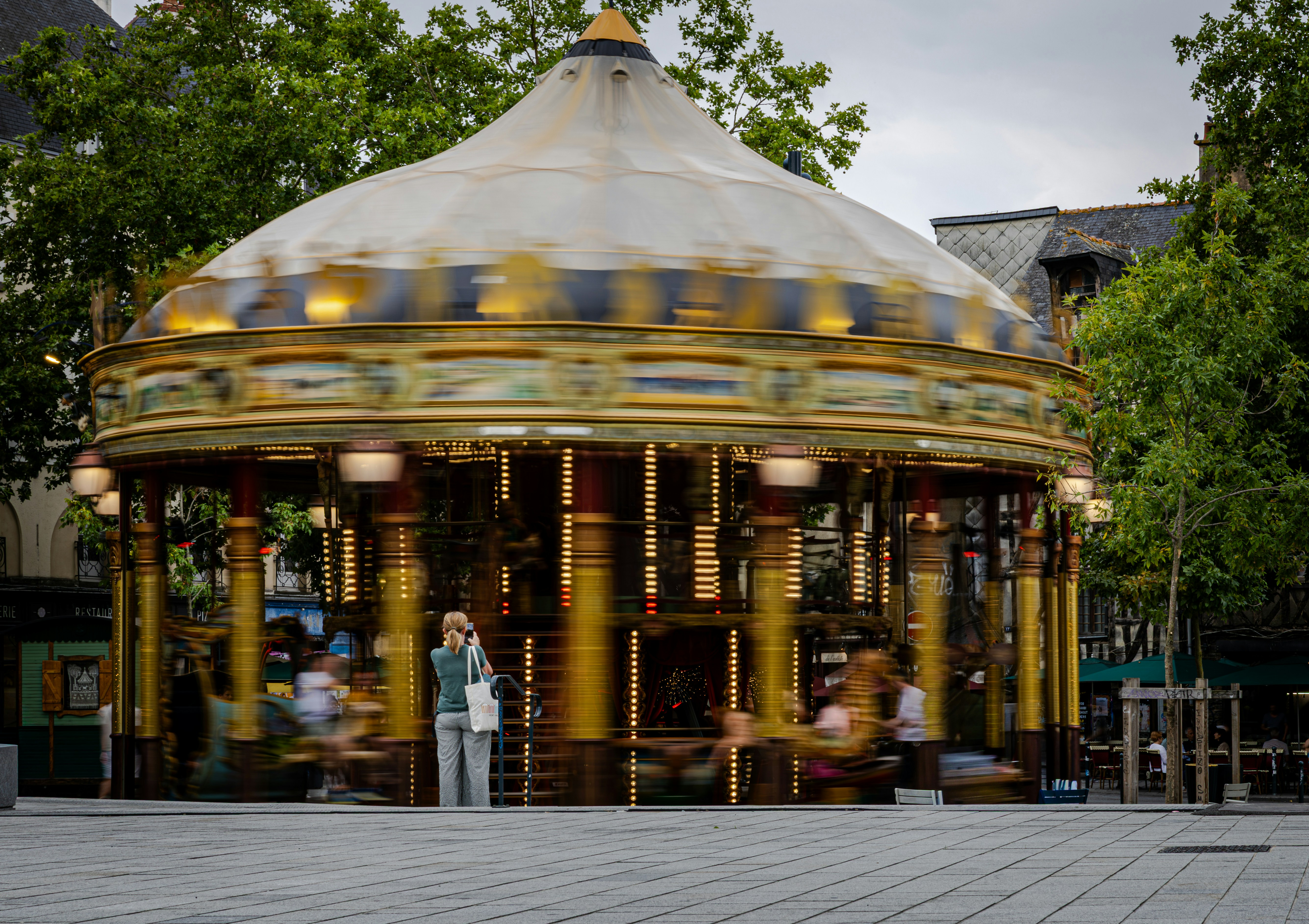 A spinning carousel with blurred figures in motion photo – Free ...