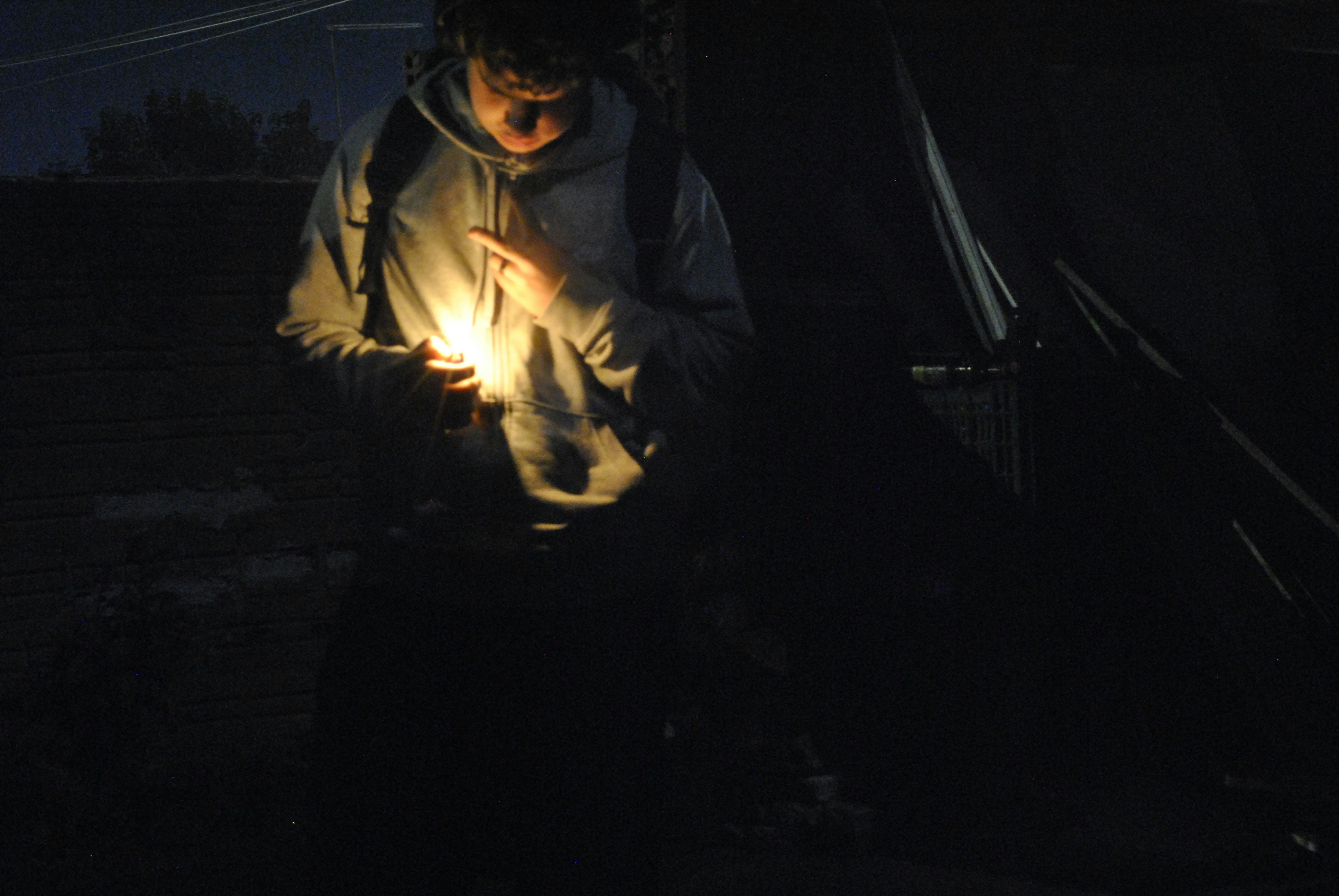 Man holding a bright light in the dark