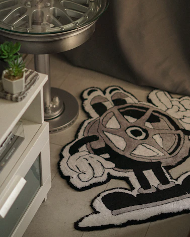 Cartoon character rug with a film reel design.