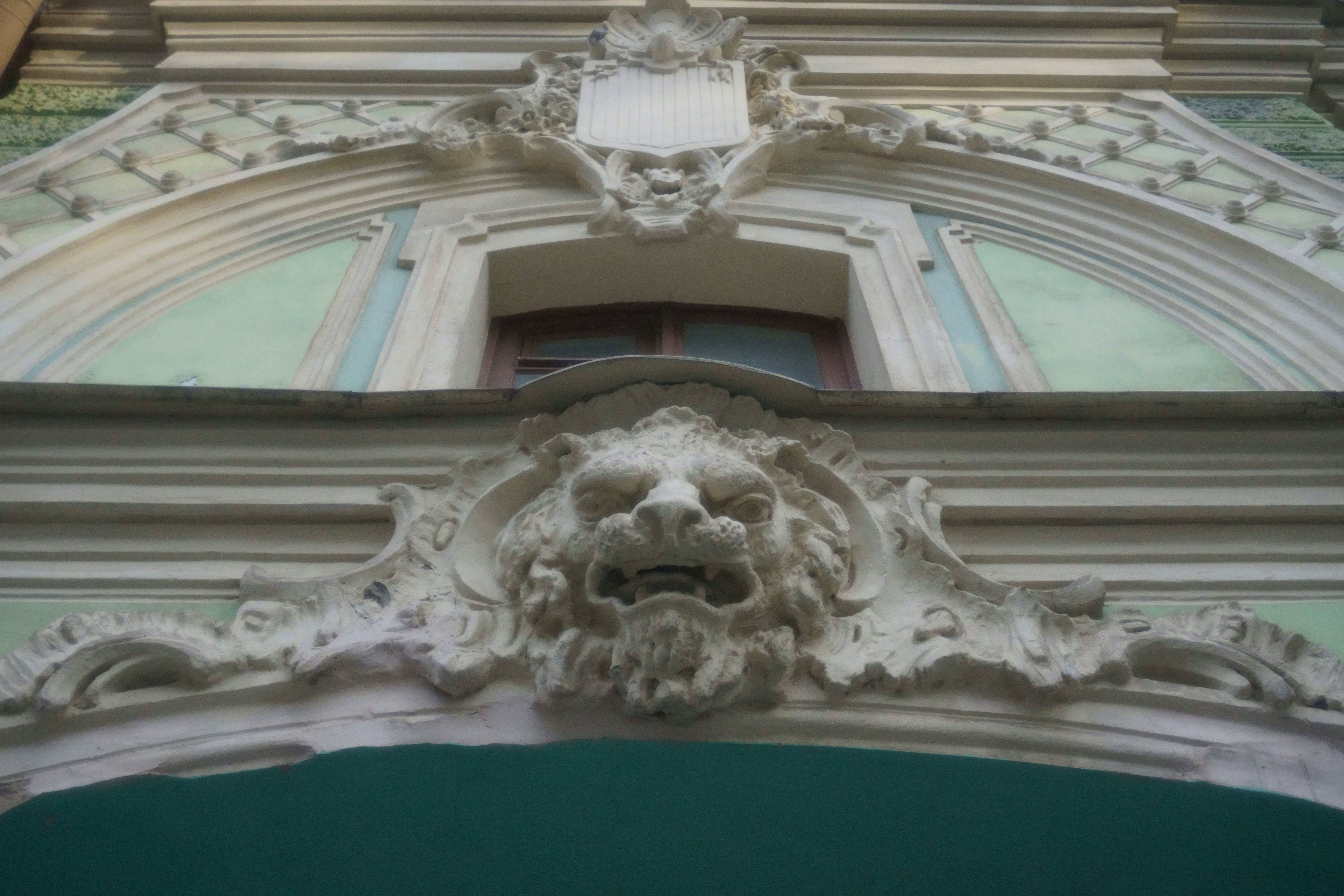 Architectural detail with a lion's head carving.