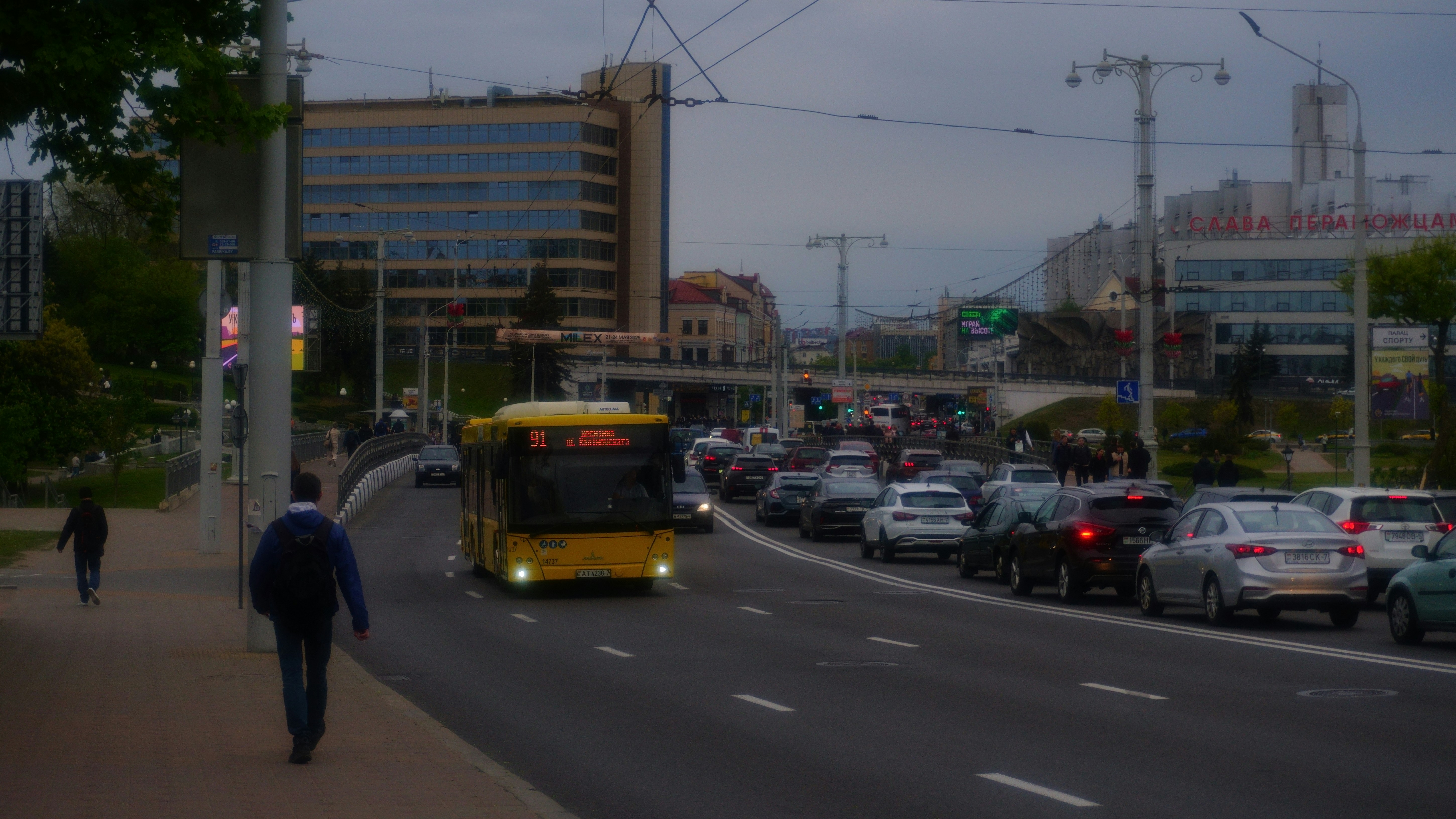 Yellow bus and traffic on a city street.