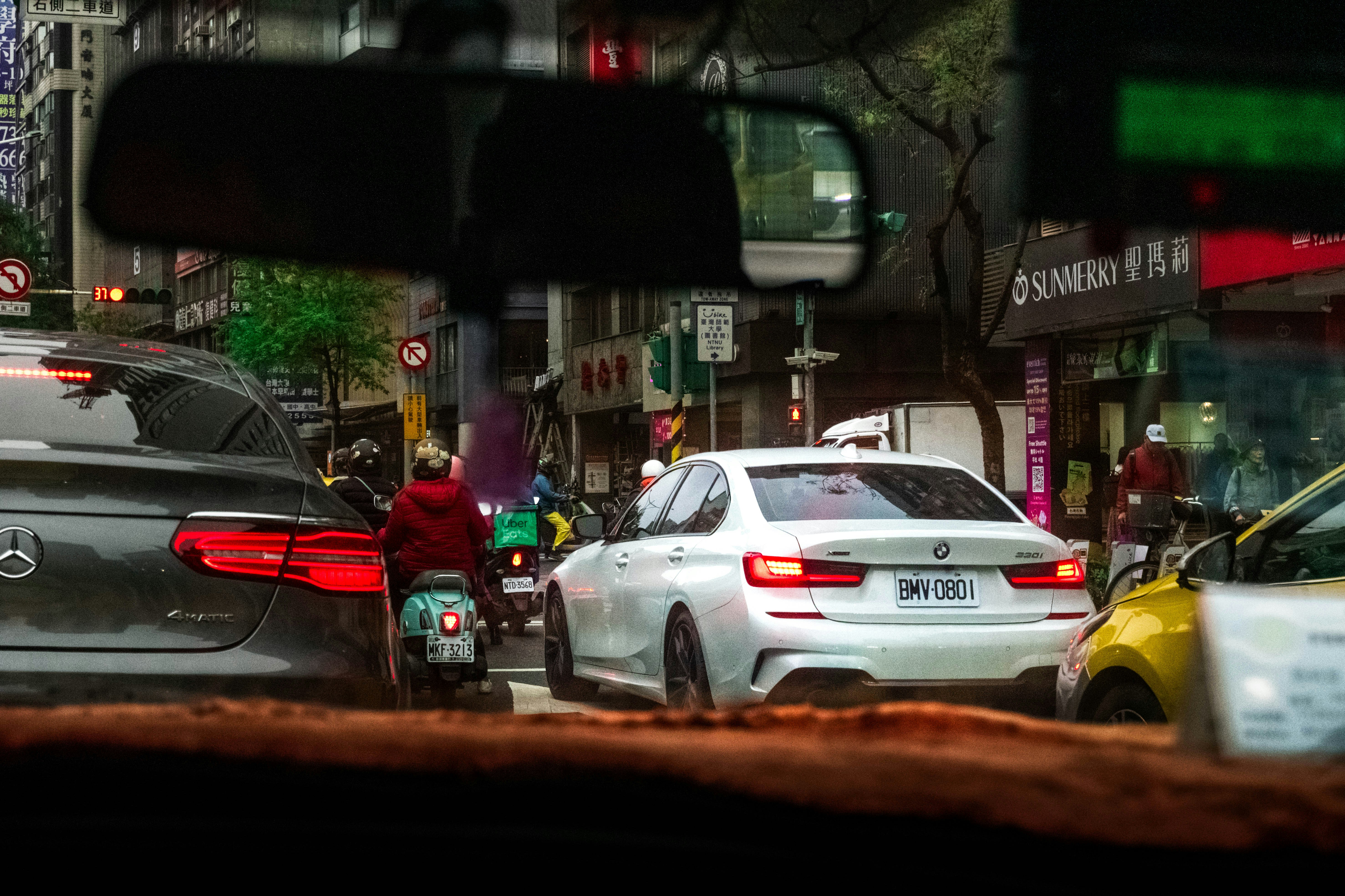Cars and scooter in city traffic jam