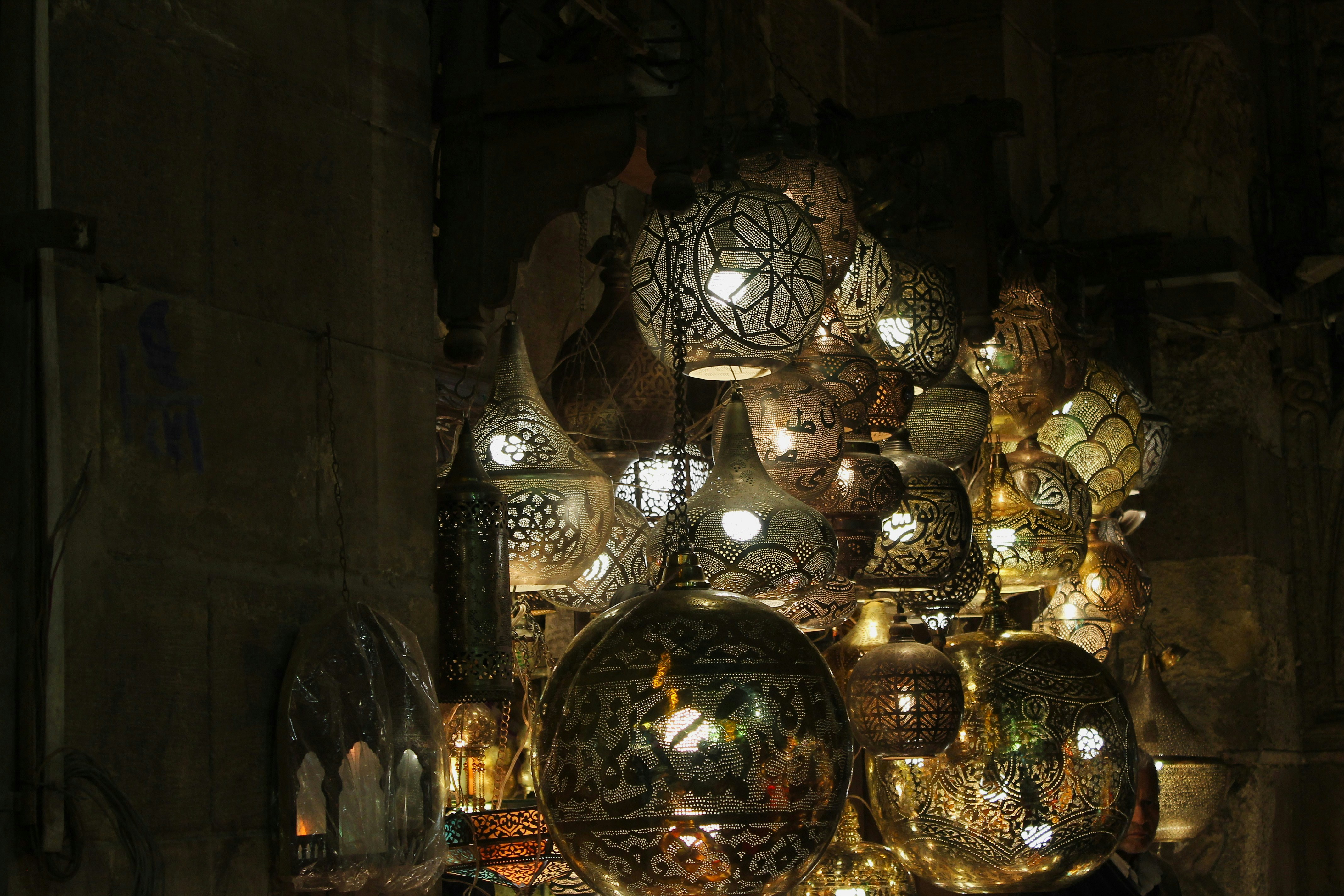 Group of ornate moroccan lanterns illuminated at night.