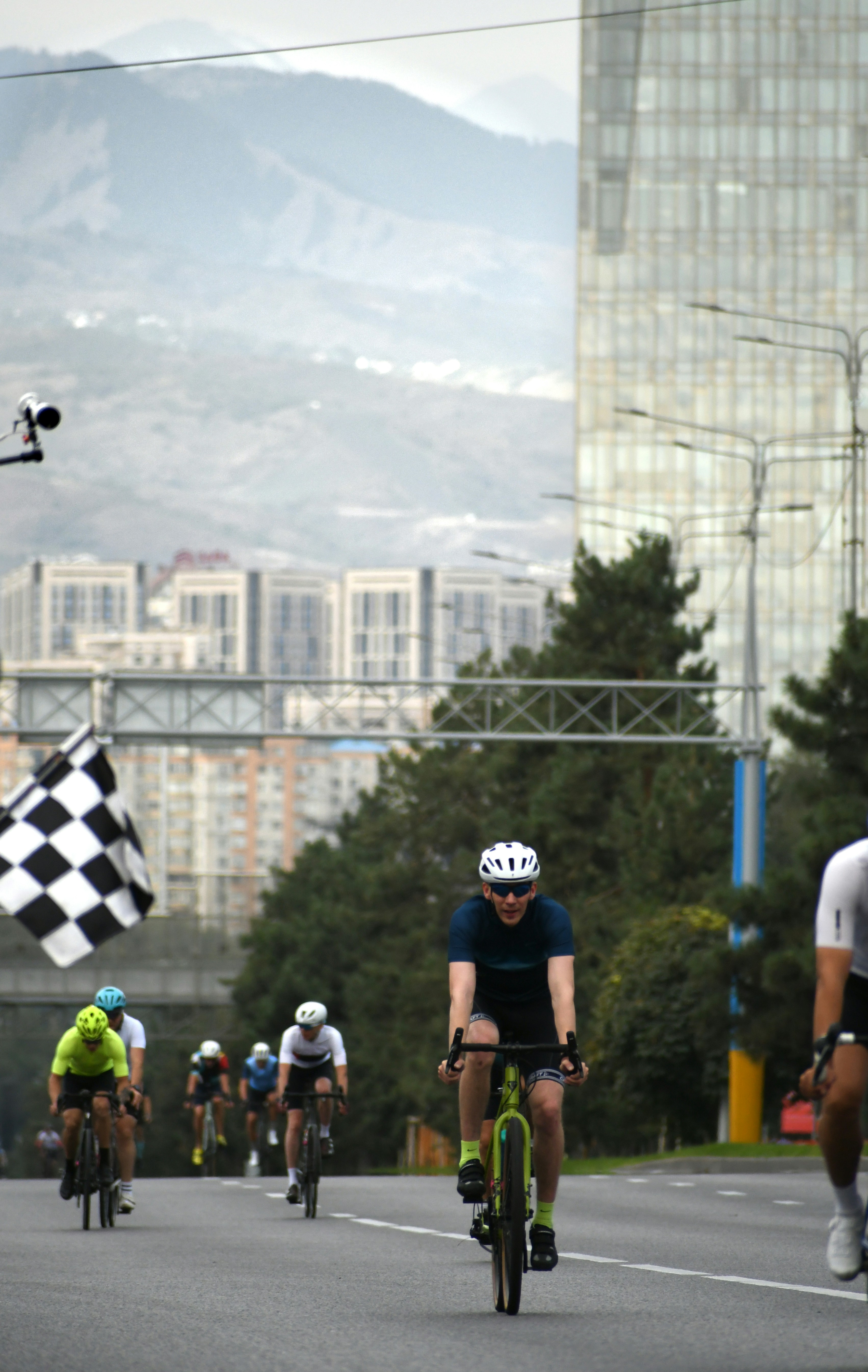 Cyclists race towards a checkered flag