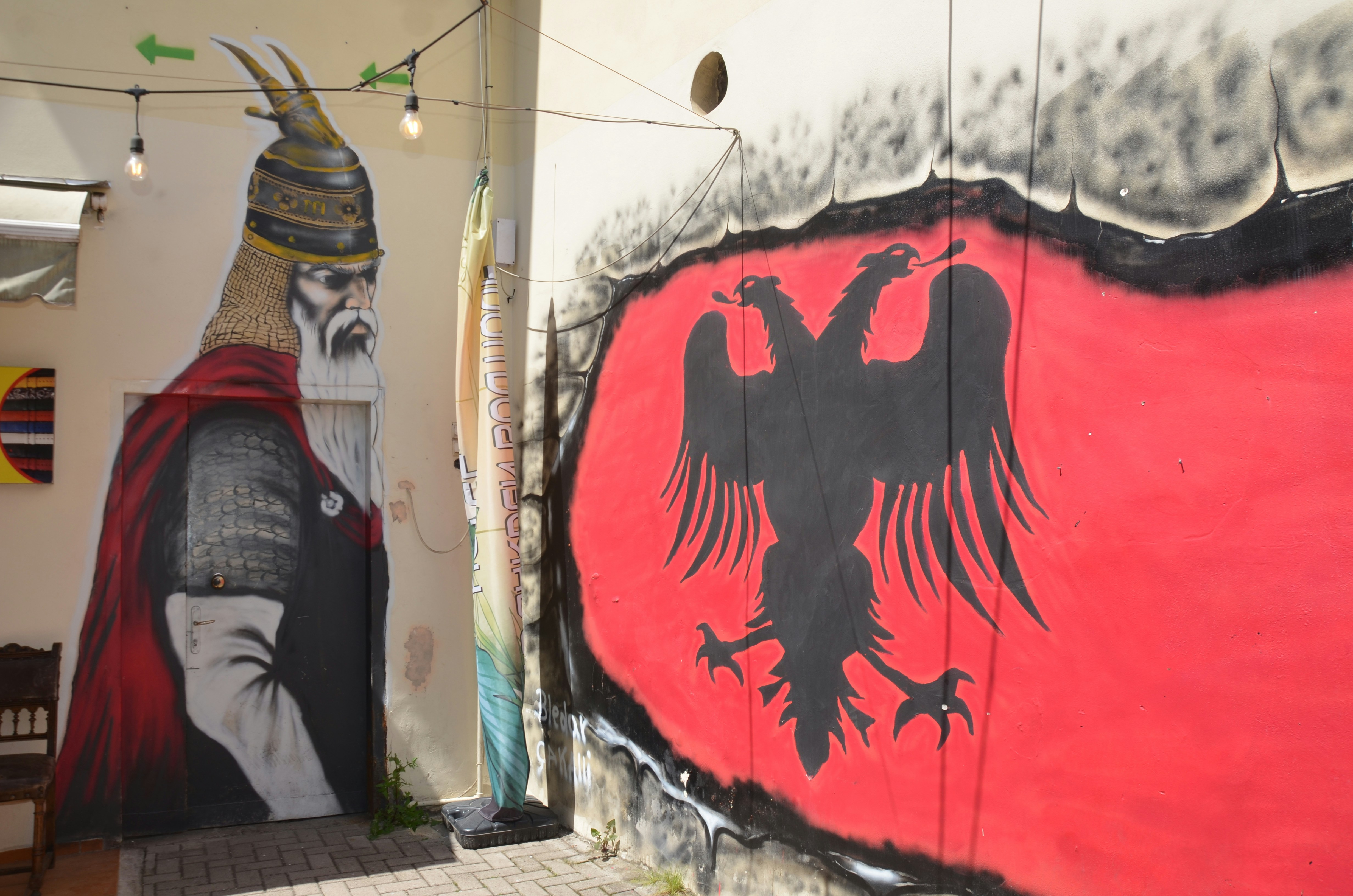 Albanian flag and historical figure mural