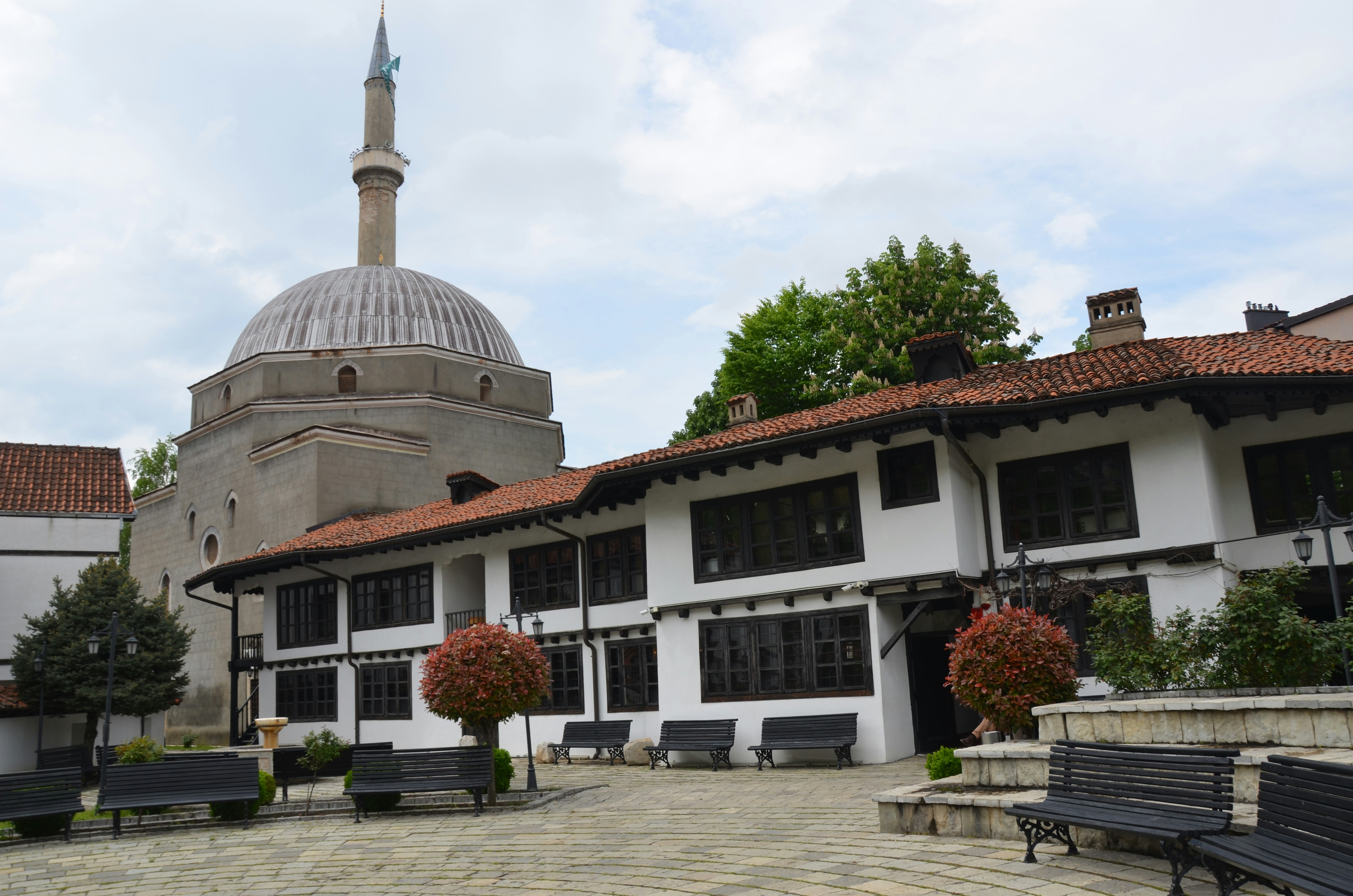 White building with red roof near mosque