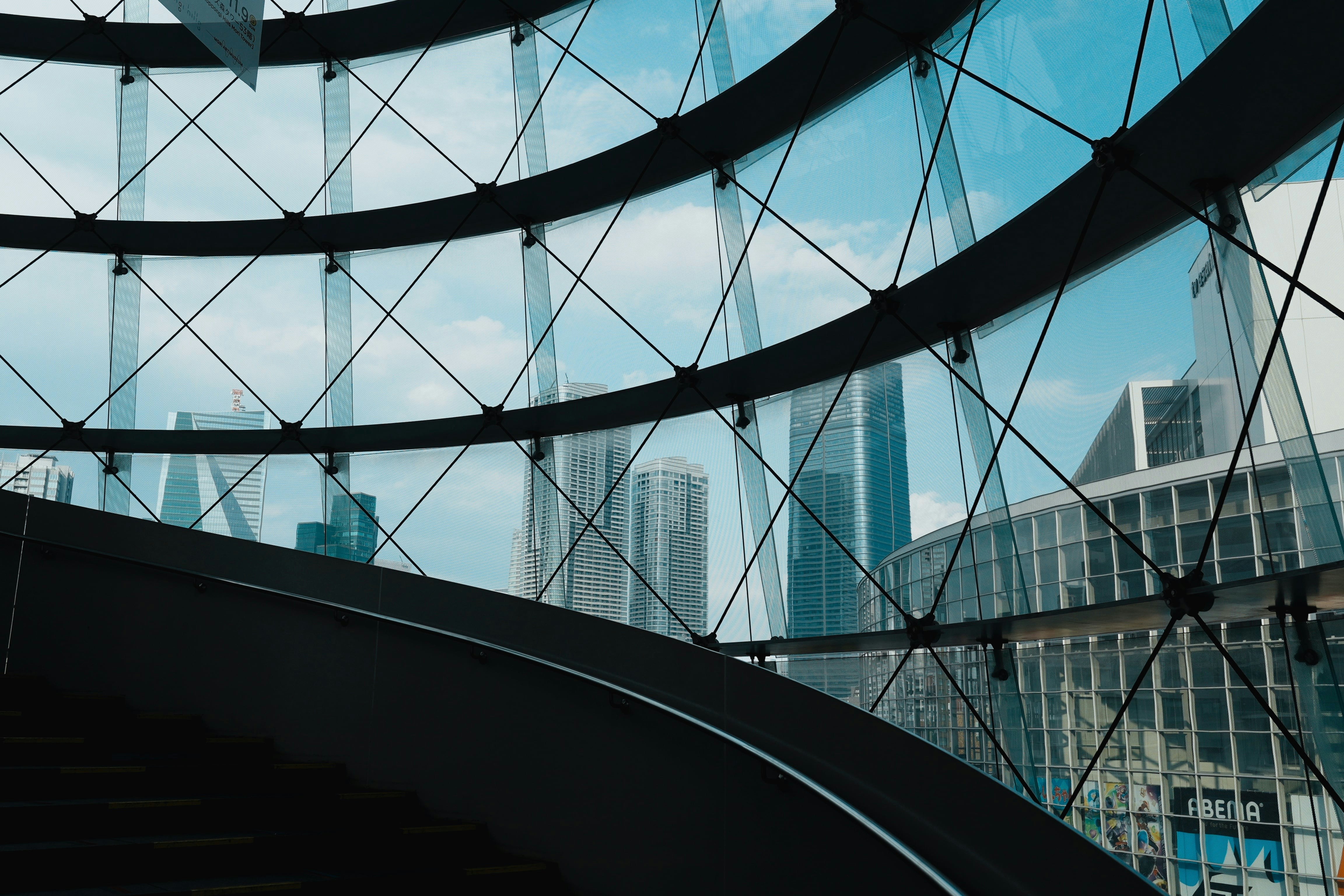 A sprawling futuristic cityscape at dusk, with flying vehicles and towering neon-lit skyscrapers.