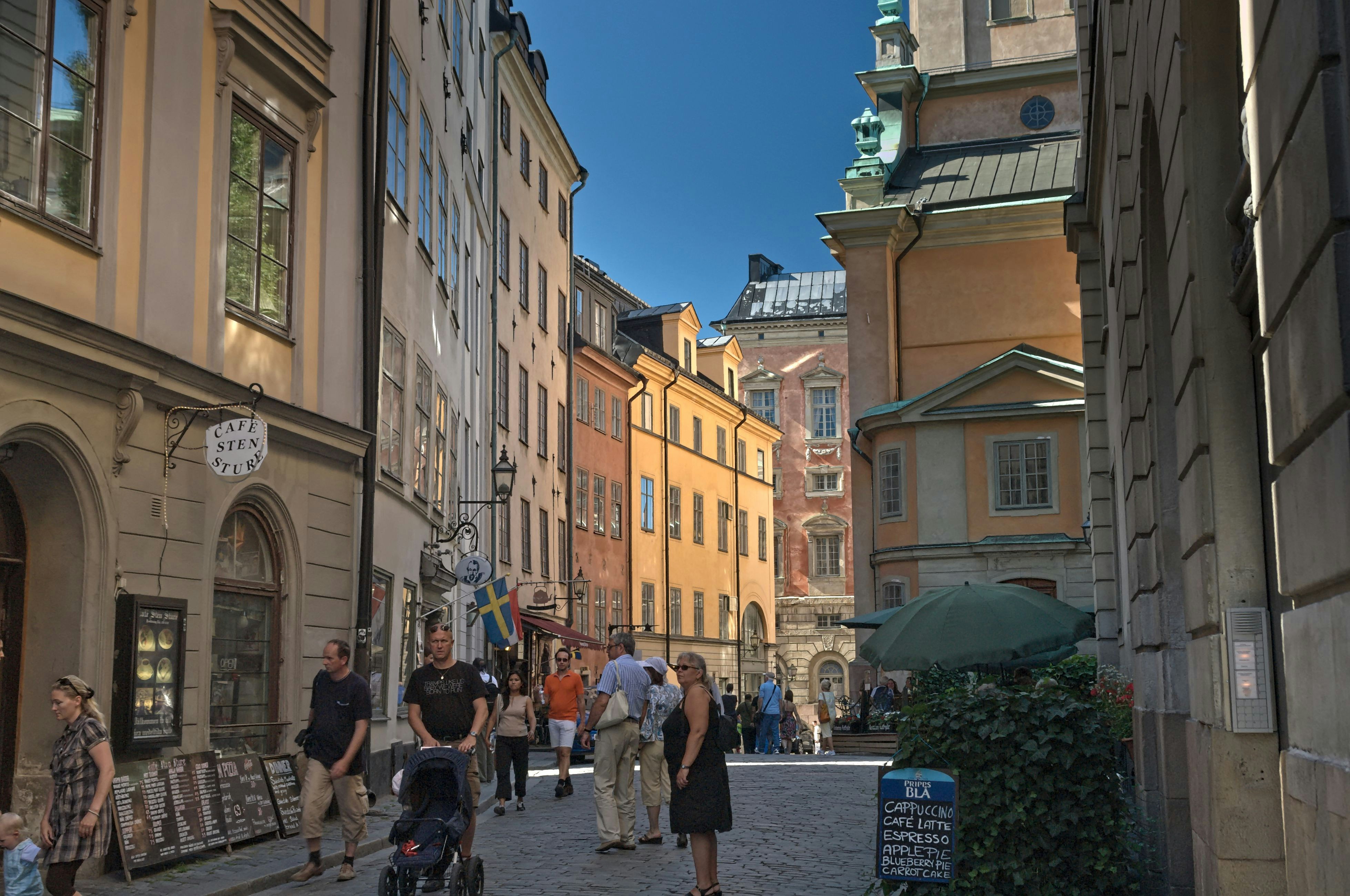 People walking down a narrow european street.