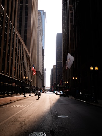 City street with tall buildings and bright sky
