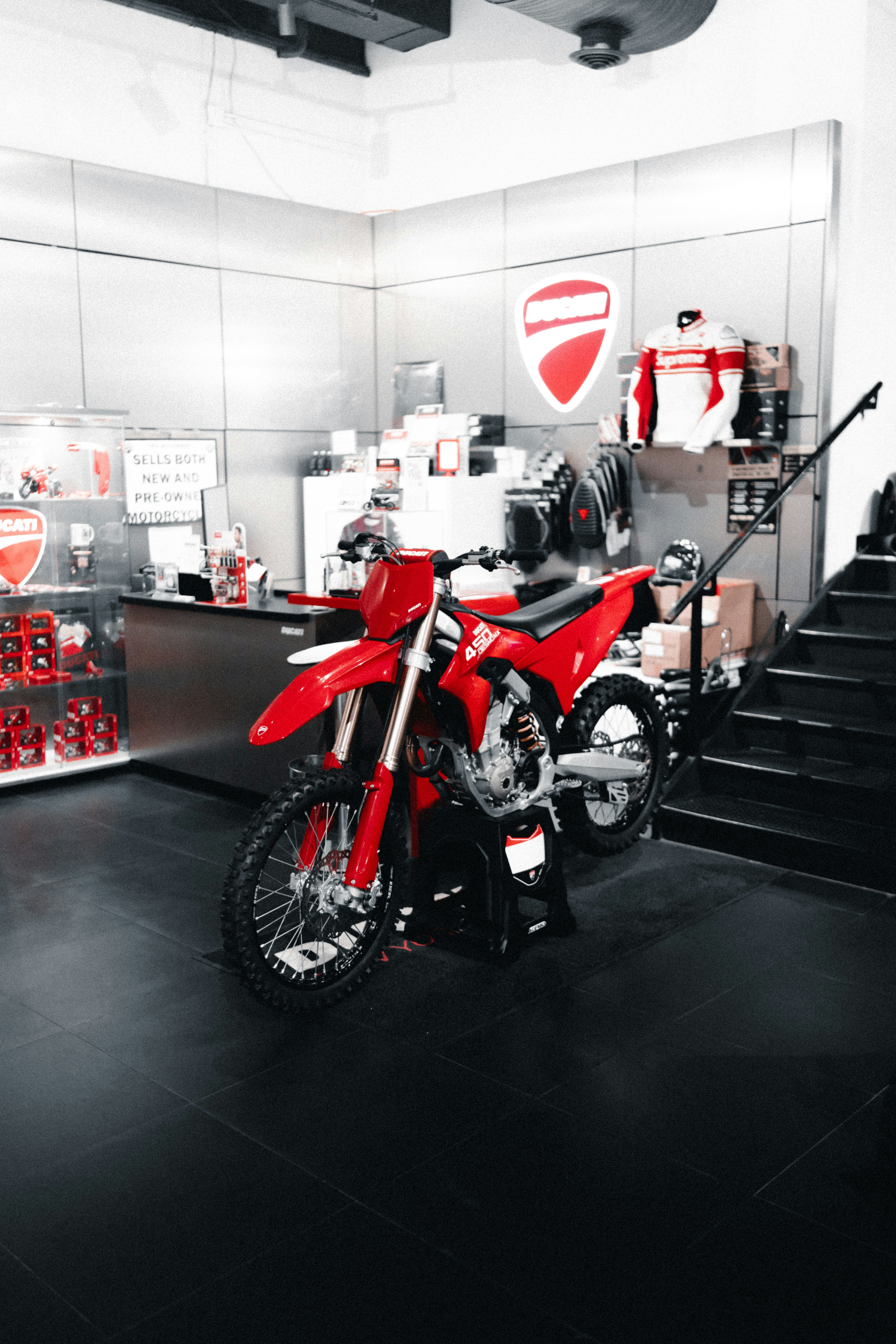 Red dirt bike displayed in a showroom