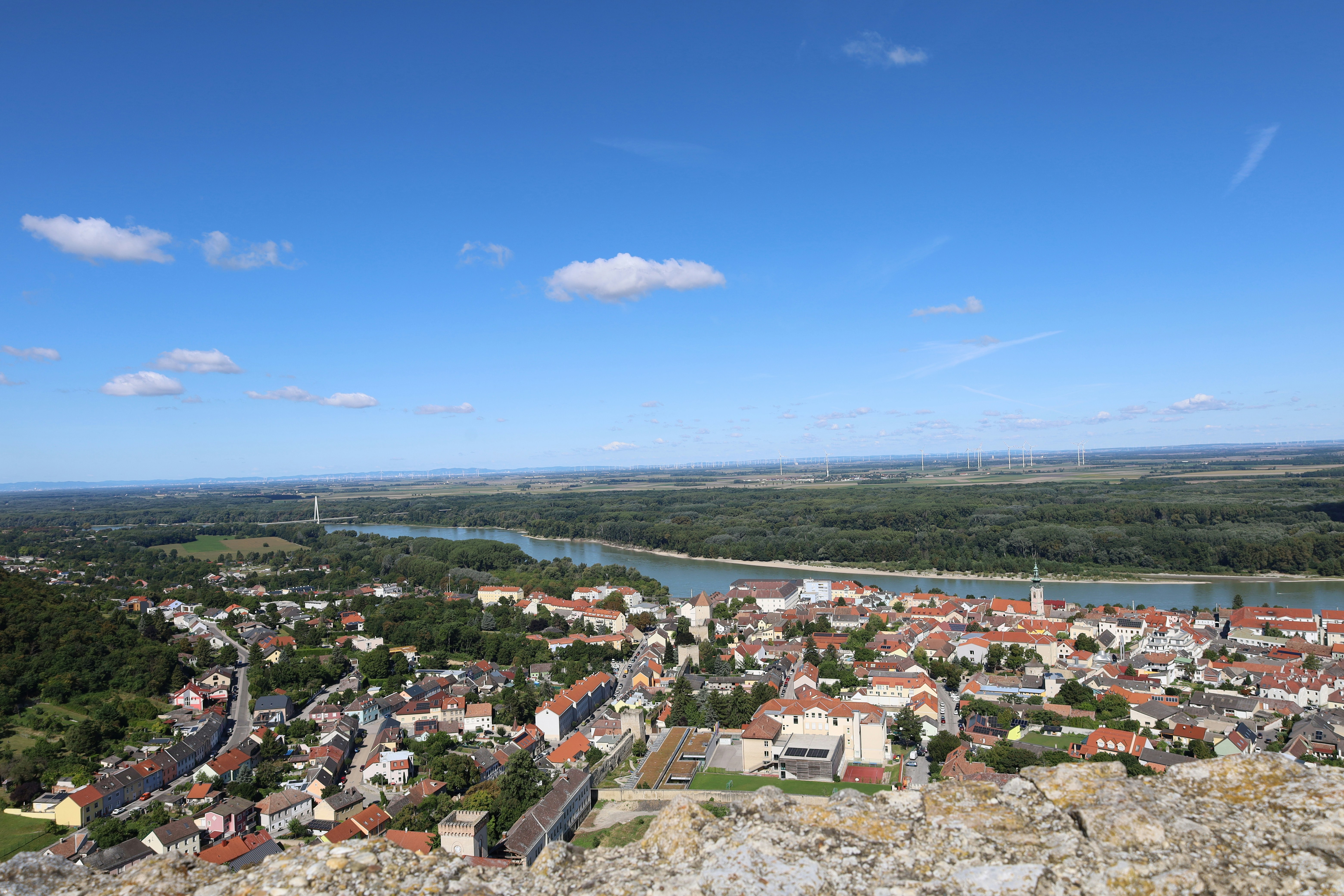 Cityscape with river and bridge under blue sky