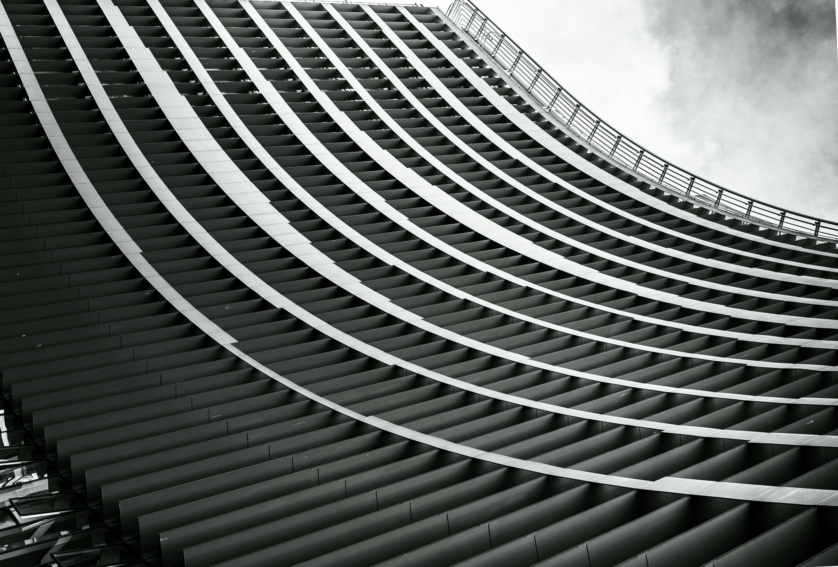 Curved building facade with repeating horizontal lines