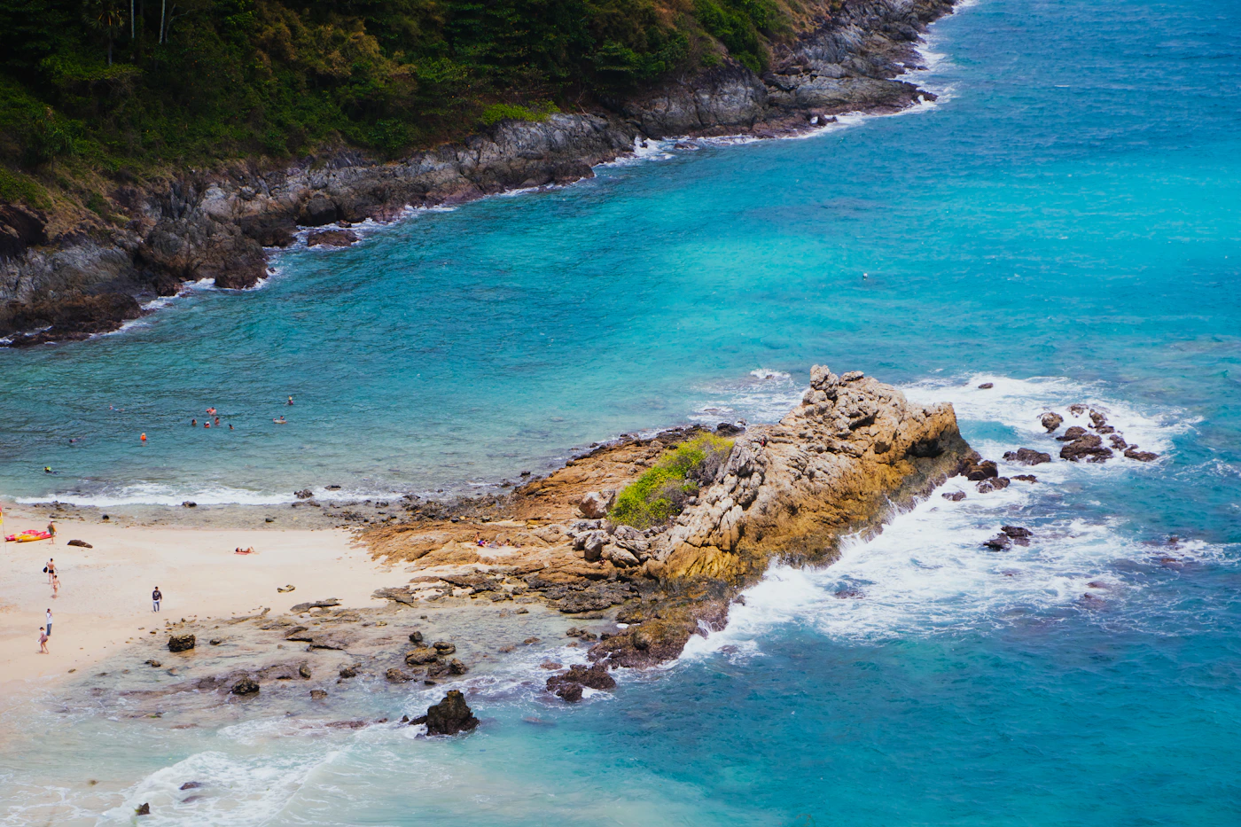 Turquoise ocean and rocky coastline at Windmill Viewpoint in Phuket, Thailand